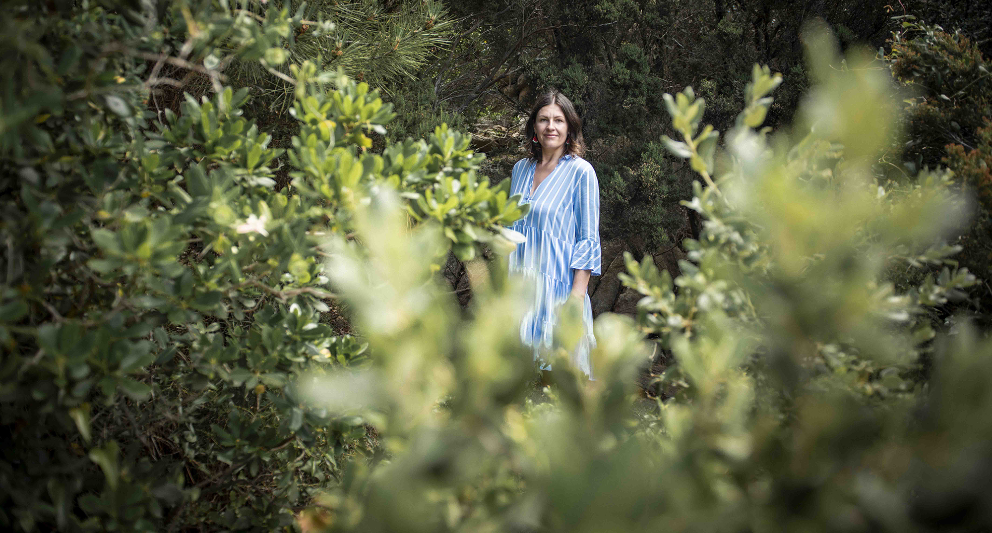 Frau mit blauem Kleid in Wald